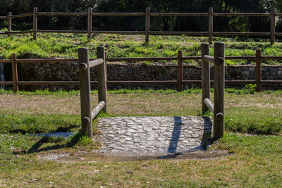 View of bench in field