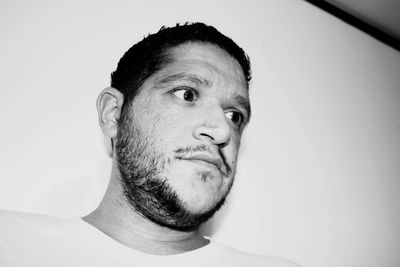 Close-up portrait of man against white background