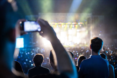 People photographing at music concert