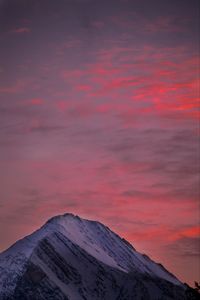 Scenic view of snow covered mountain against sky at sunset