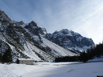 Scenic view of snow covered mountains against sky