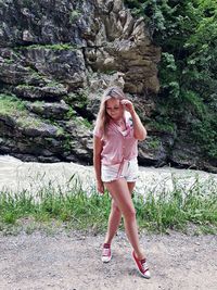 Full length of young woman against mountain