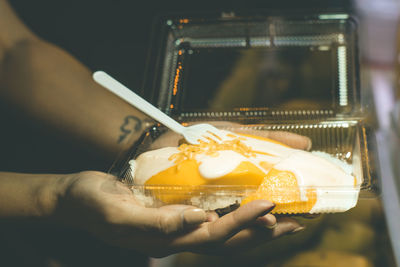 Close-up of person hand holding ice cream