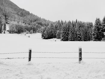 Snow on field against sky during winter