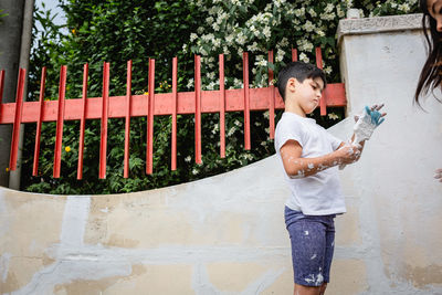 Full length of man standing against wall