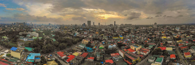 High angle view of city buildings against sky during sunset