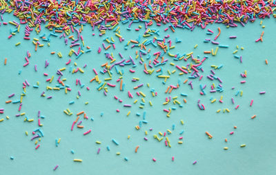 Close-up of multi colored sprinkles on blue background