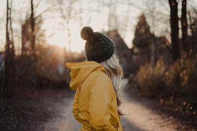 Rear view of boy walking in winter