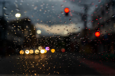 City seen through wet glass window in rainy season
