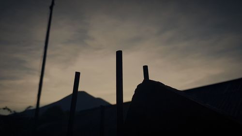 Low angle view of silhouette building against sky at sunset