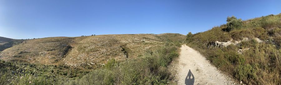 Scenic view of land against clear blue sky