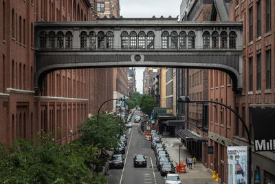 Vehicles on road amidst buildings in city