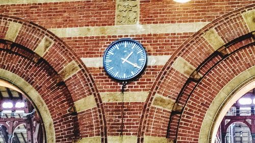 Low angle view of clock on wall