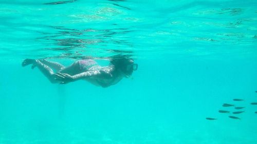 Swimming underwater in pool