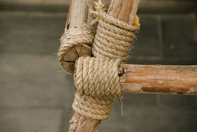 Close-up of rope tied on wooden post