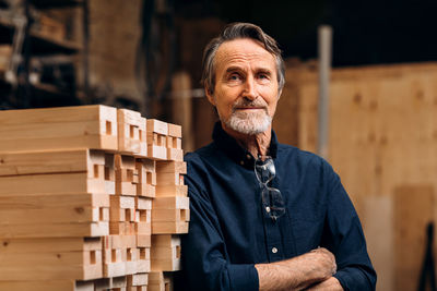 Portrait of carpenter standing in factory