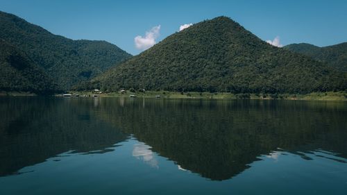 Scenic view of lake and mountains against sky