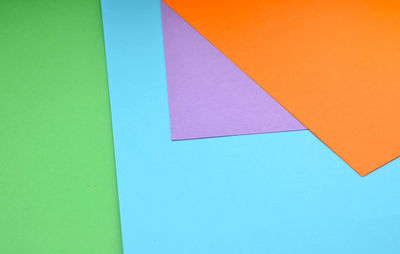 Low angle view of multi colored umbrella against clear blue sky