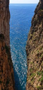 Rock formations by sea against sky