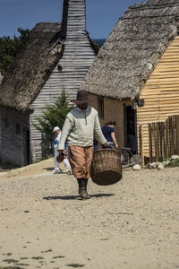 Full length of man walking on houses