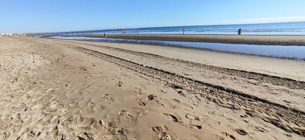 Scenic view of beach against clear sky