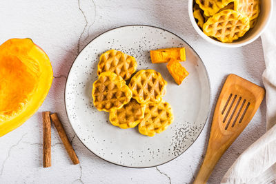 Pumpkin waffles on a plate on the table. homemade baking. top view