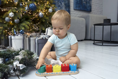 Cute girl playing with christmas tree