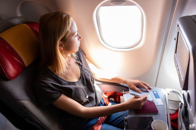 Young woman sitting in airplane