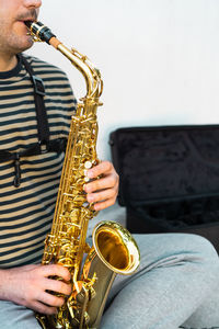 Midsection of man playing guitar