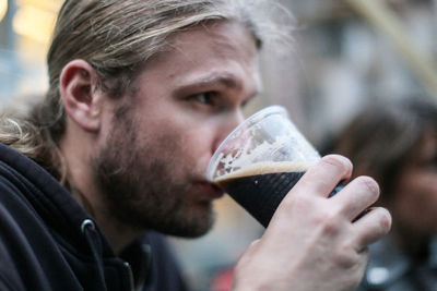 Close-up of man drinking beer