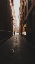 People walking on road amidst buildings in city