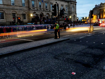 Blurred motion of man walking on road at night