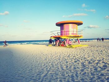 Scenic view of beach against cloudy sky