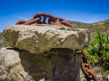 Rusty chain over a rock