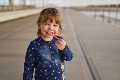 Portrait of smiling girl standing outdoors