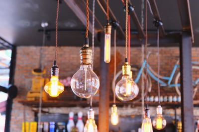 Illuminated light bulbs hanging from ceiling