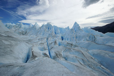 Scenic view of snow mountains against sky