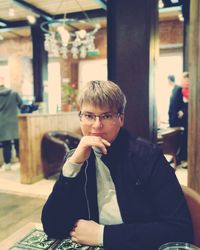 Portrait of man sitting on table