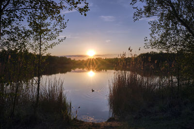 Scenic view of lake against sky during sunset