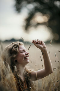 Portrait of smiling young woman looking up