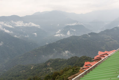 High angle view of houses and mountains against sky