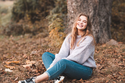 Smiling teenage girl 16-17 year old wearing casual clothes outdoors. look at camera. autumn season