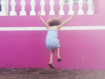 Rear view of girl jumping