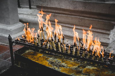 High angle view of burning candles in temple