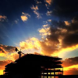 Low angle view of built structure against cloudy sky