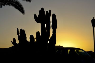 Silhouette people against sky during sunset