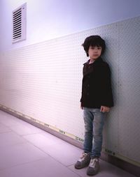 Boy standing against wall