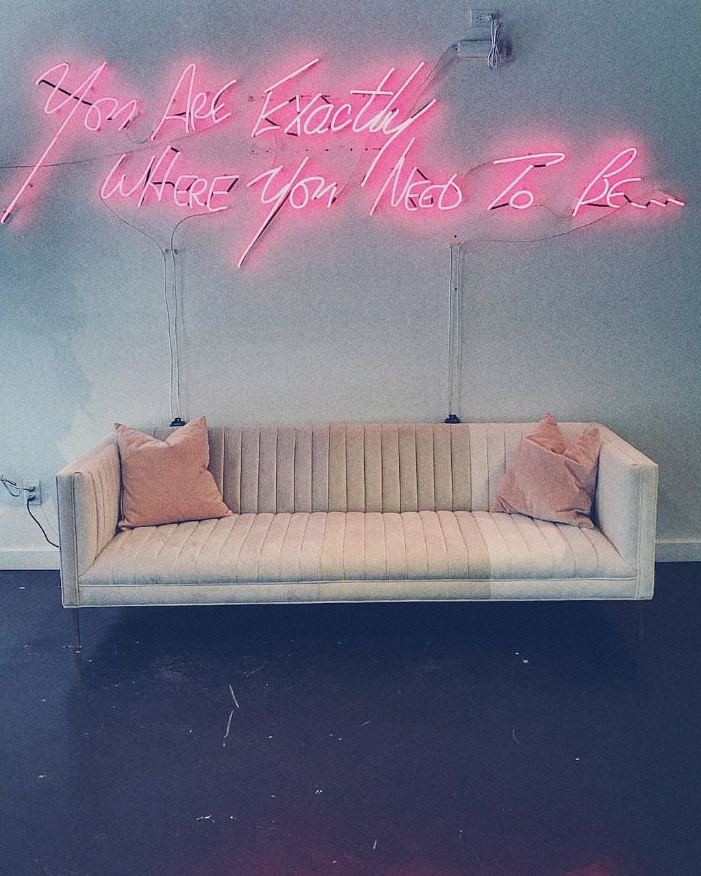 text, indoors, western script, furniture, communication, sofa, no people, pink color, pillow, absence, domestic room, home interior, lighting equipment, stuffed, bed, illuminated, cushion, sign, day, seat