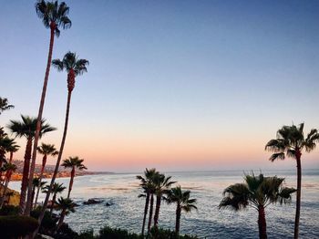 Scenic view of sea against clear sky at sunset