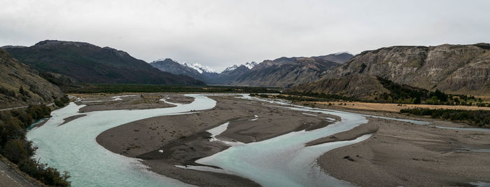 Scenic view of valley snowcapped mountains against sky